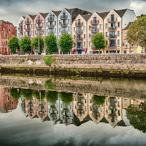 coloured houses in cork with reflection in river lee